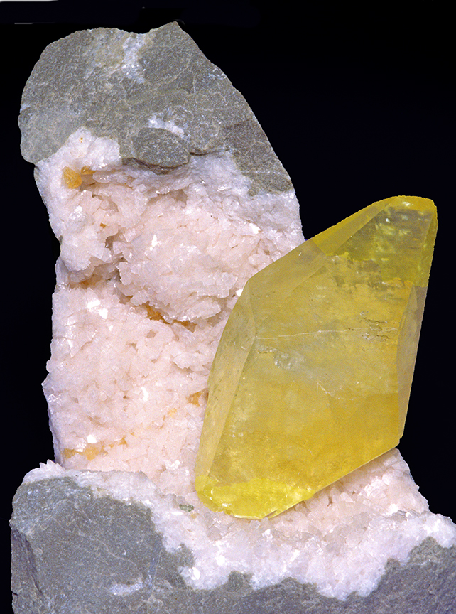 Calcite on dolomite crystals  in vug within dolostone.jpg