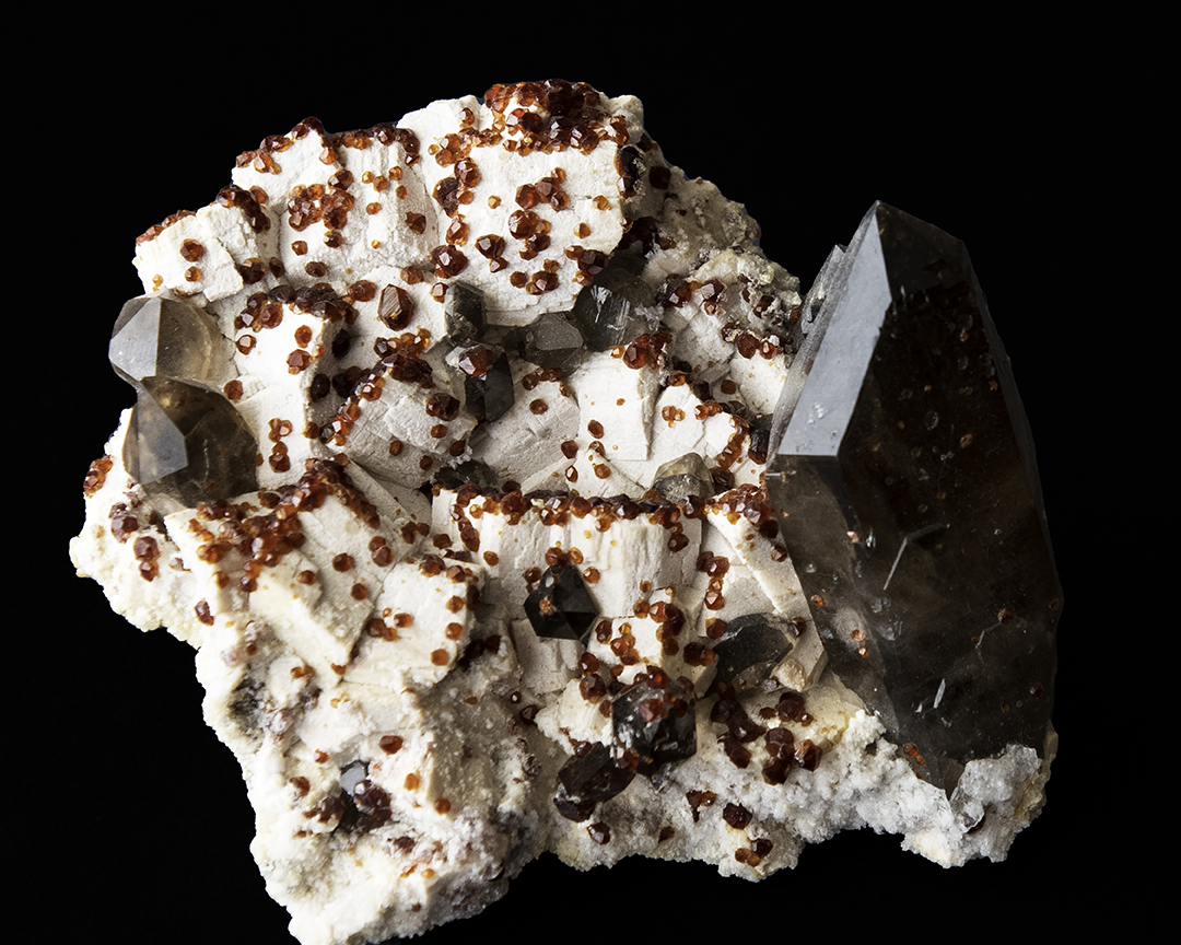 Garnet and Smokey Quartz, on feldspar matrix.jpg