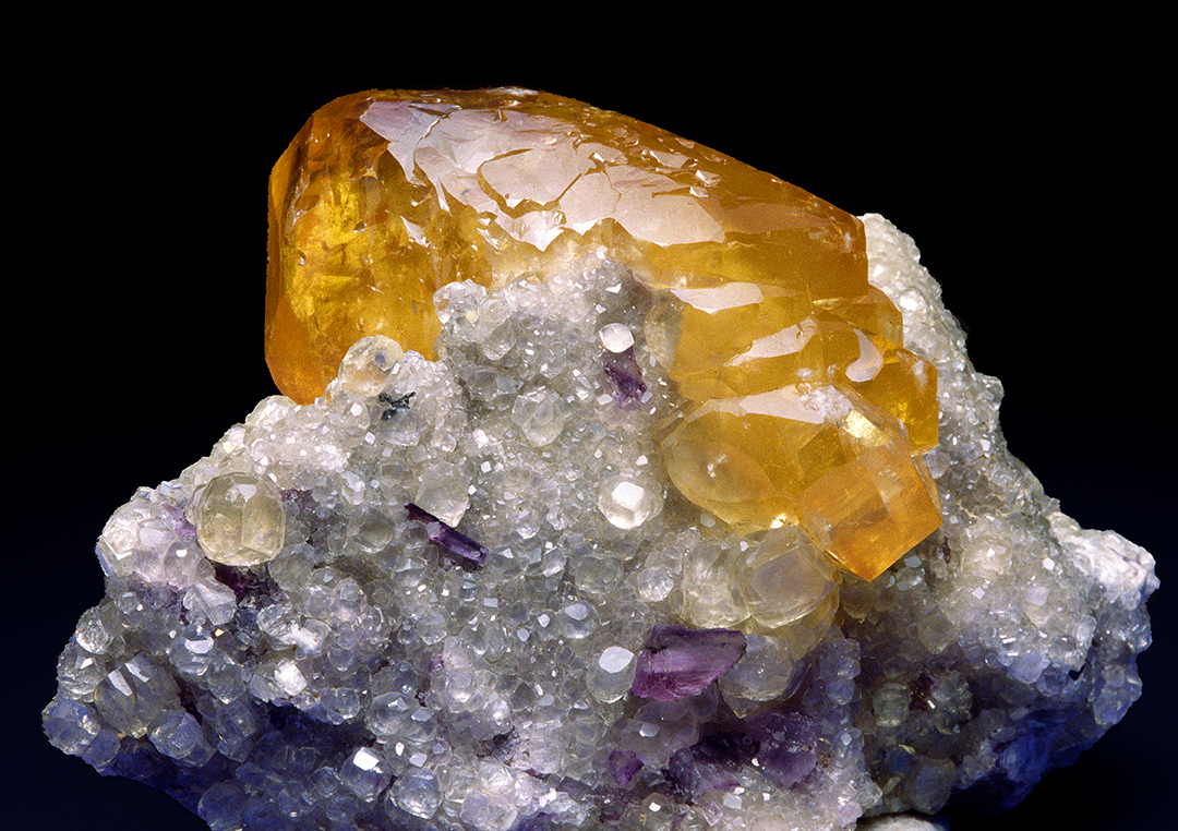 (MIN2) Large yellow calcite crystal on matrix of smaller clear calcite crystals, Denton Mine, ...jpg